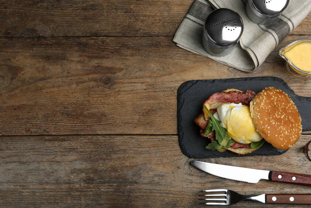 Delicious egg Benedict served on wooden table, flat lay. Space for text - Foto, Imagem