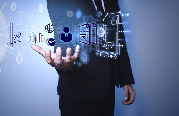 Man demonstrating icons of data management system on light background, closeup - Photo, Image
