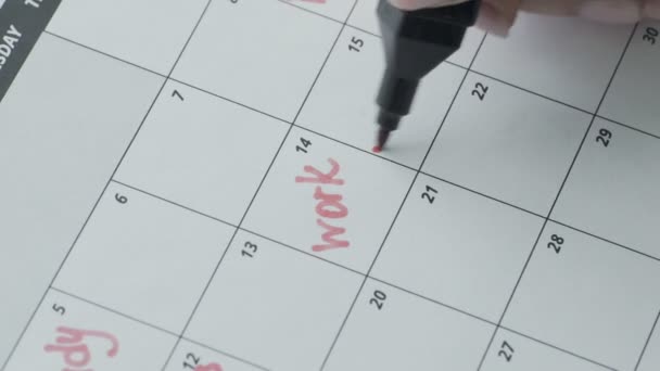 Macro of the hand writing a word work in the schedule under the date of 15 - Footage, Video