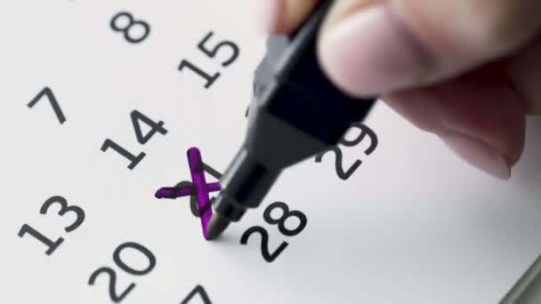 Woman hand cross 21st day of the month on paper calendar - Footage, Video