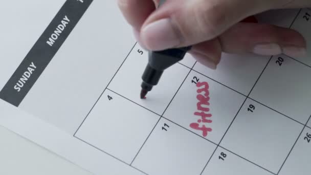 Womans hand writing with red felt pen on calendar word study - Footage, Video