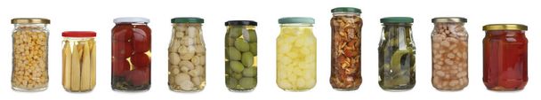 Set of different jars with pickled vegetables and mushrooms on white background. Banner design - Foto, imagen