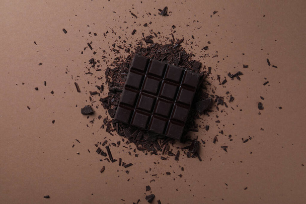 Tasty dark chocolate on brown background, flat lay - Photo, image