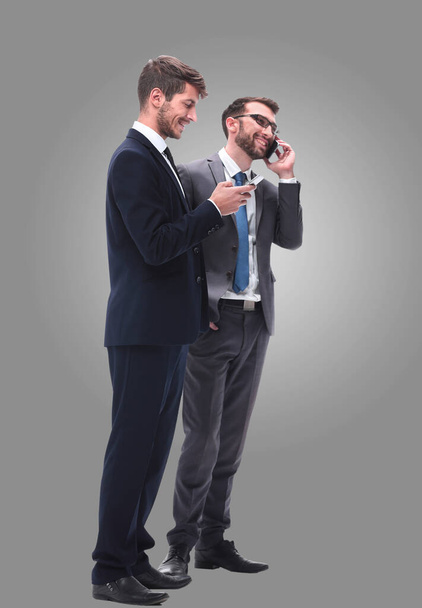 full length . two businessmen using their smartphones - Fotoğraf, Görsel