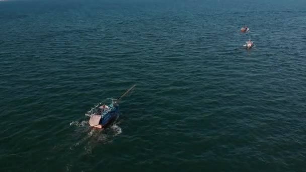 Professional fishing vessel returns to the port in the morning in the sunshine after fishing,shooting from drone of an Asian fishing schooner a boat with crab traps for squid and lobster at high speed - Footage, Video