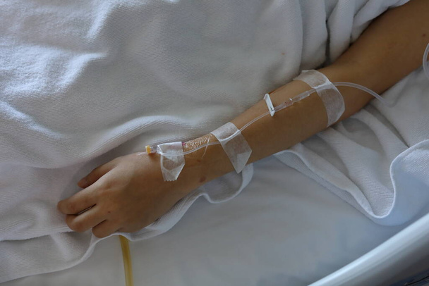 iv infusion intravenous injection of patient illness lying on bed - Φωτογραφία, εικόνα