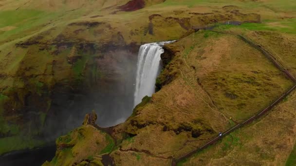 Flying near Skogafoss Waterfall in the South of Iceland. Aerial shot of high water cascades and a colorful rainbow apperance. Travel - Footage, Video