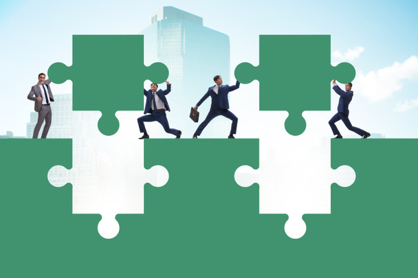 Businessman in teamwork concept with jigsaw puzzle - Photo, Image