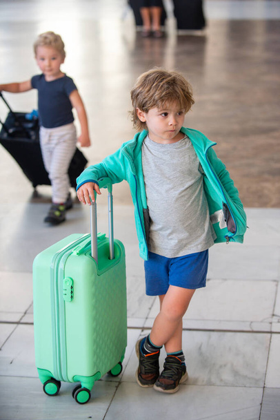 Traveling alone. A boy with a suitcase at the airport. - Photo, Image