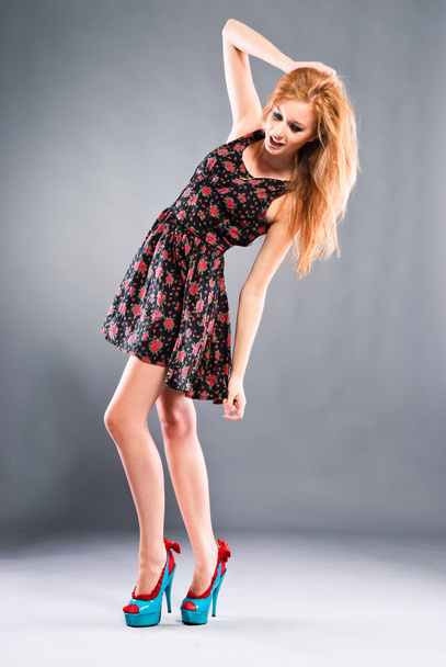 Beautiful red-haired girl on grey background - Valokuva, kuva