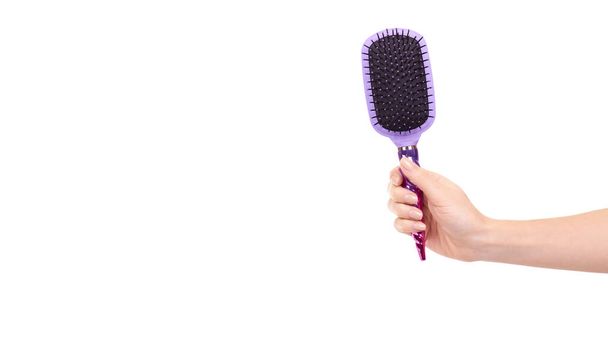 Hand with purple hairbrush, hair care and beauty. Isolated on white background. Copy space, template. - Zdjęcie, obraz