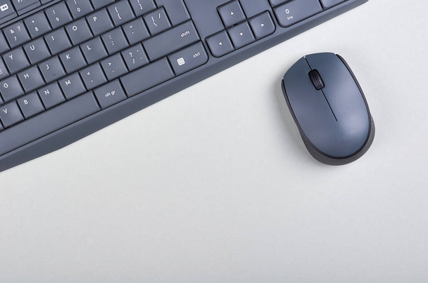 Keyboard and mouse on grey background. Flat lay, overhead view image. Copy space, template. - Photo, Image