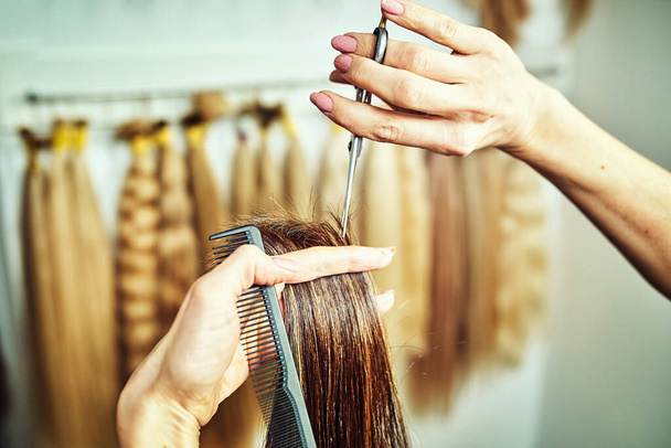 cropped image of hairdresser trimming ends of blonde hair - 写真・画像