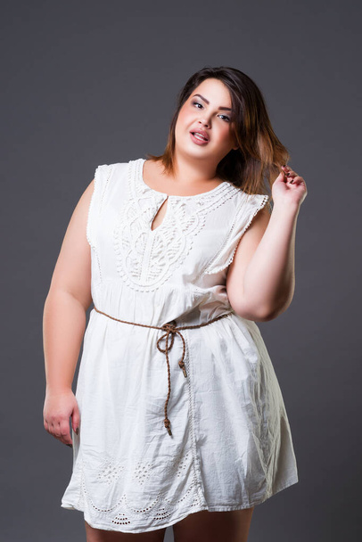 Plus size fashion model in casual clothes, fat woman on gray background, body positive concept - Foto, Bild