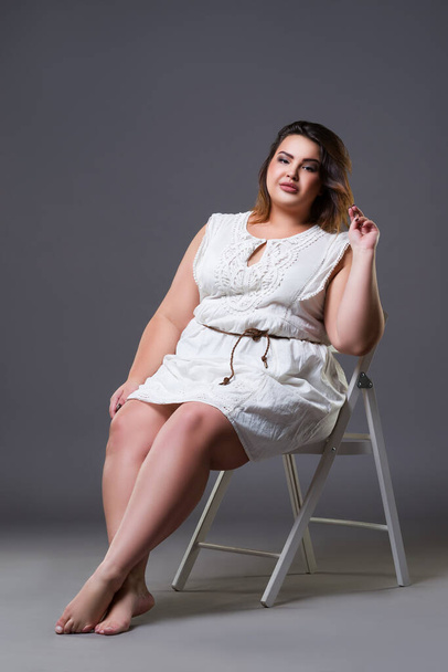Plus size fashion model in casual clothes, fat woman on gray background, body positive concept - Foto, Imagem