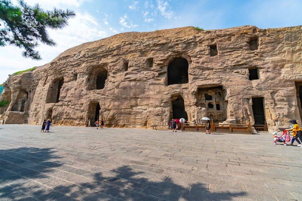 Facade of niches and caves where sculpted inside the mountain. Yungang Grottoes  near Datong, Shanxi Province, China  - Foto, Imagen