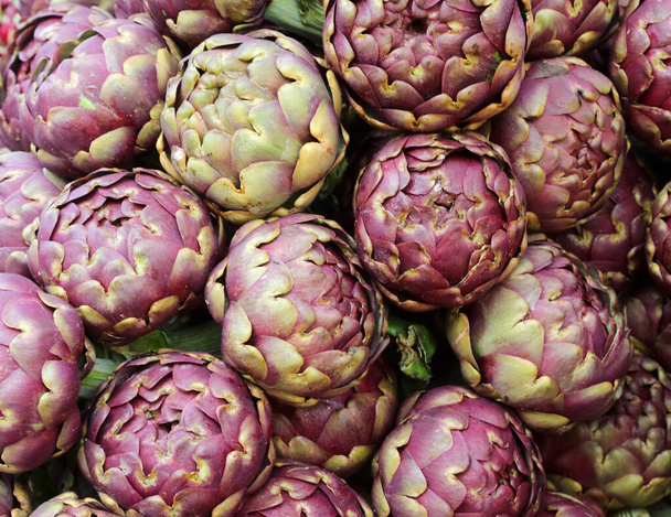 green big artichokes on sale in the greengrocer stall at the market - Photo, Image