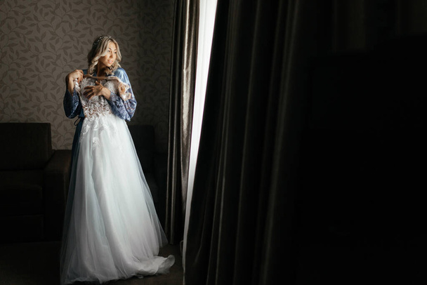 Novia probándose su vestido de novia en la mañana
 - Foto, Imagen