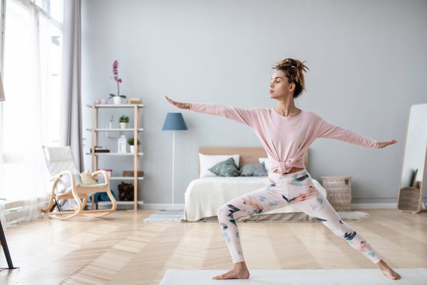 Attractive woman practicing yoga at home interior. lifestyle concept. - Fotoğraf, Görsel