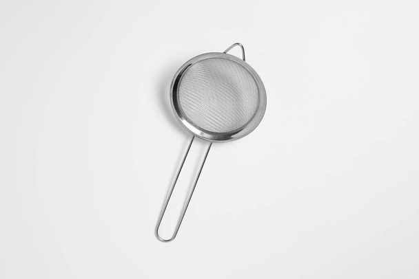 Metal sieve colander isolated on white background. Metallic strainer with handle. High-resolution photo. - Photo, Image