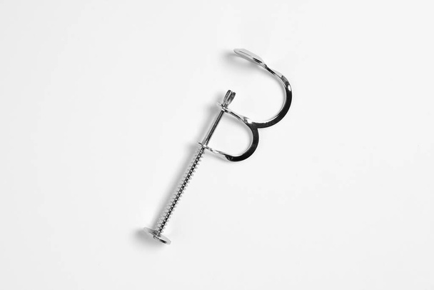 Cherry Pitter. Cherry and olive stoner on a white background. A tool for removing cores from fruit.High-resolution photo. - Foto, Imagen