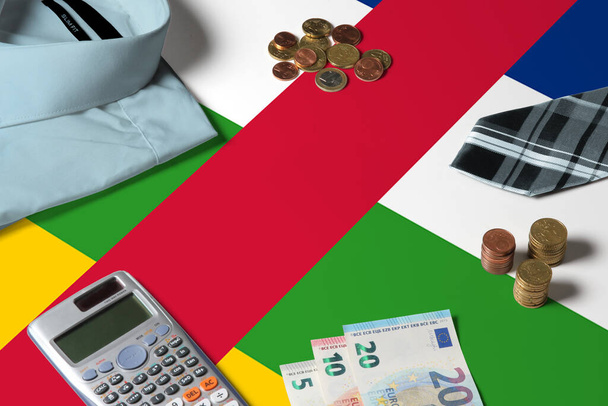 Central African Republic flag on minimal money concept table. Coins and financial objects on flag surface. National economy theme. - Fotografie, Obrázek