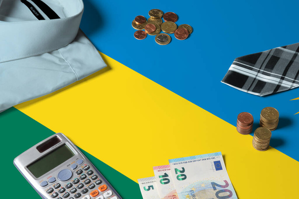 Rwanda flag on minimal money concept table. Coins and financial objects on flag surface. National economy theme. - Fotografie, Obrázek