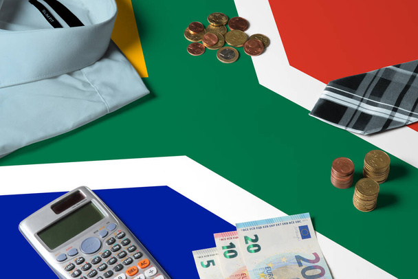 South Africa flag on minimal money concept table. Coins and financial objects on flag surface. National economy theme. - Fotografie, Obrázek