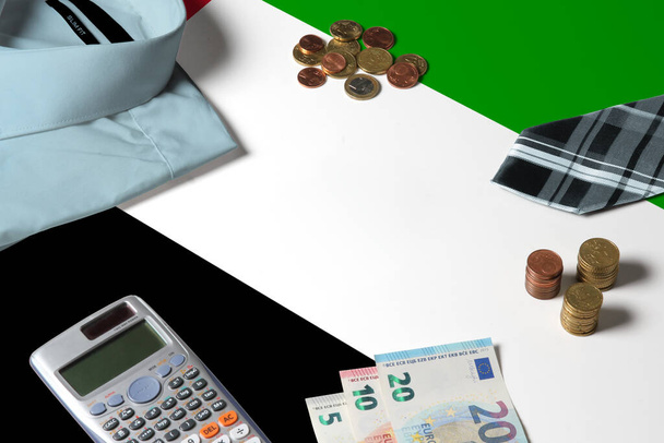 United Arab Emirates flag on minimal money concept table. Coins and financial objects on flag surface. National economy theme. - Fotografie, Obrázek