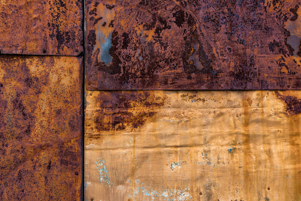 Rusted flat composite nailed metal sheets surface background and texture. - Photo, Image