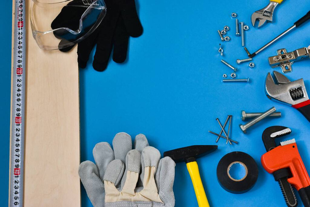 Professional repair tools for decoration and building repair on a blue background. View from above. Place for text - Photo, Image