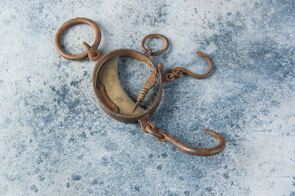 Antique brass iron rusty hand scales with hooks  on concrete background. Copy space for text. - Photo, Image