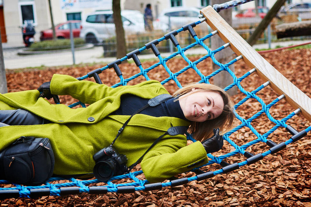 woman with a camera is resting lying in a hammock. - Foto, imagen