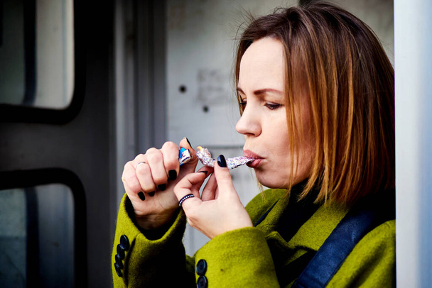 A woman smokes marijuana. Hemp, hash as a means of relaxation. - Zdjęcie, obraz