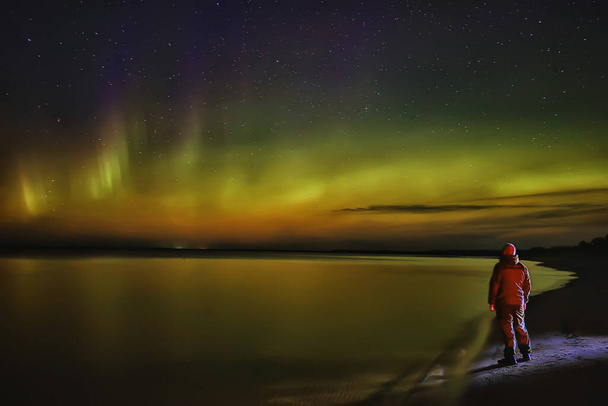 northern lights lonely man lakeside beautiful nature night sky landscape - Foto, afbeelding
