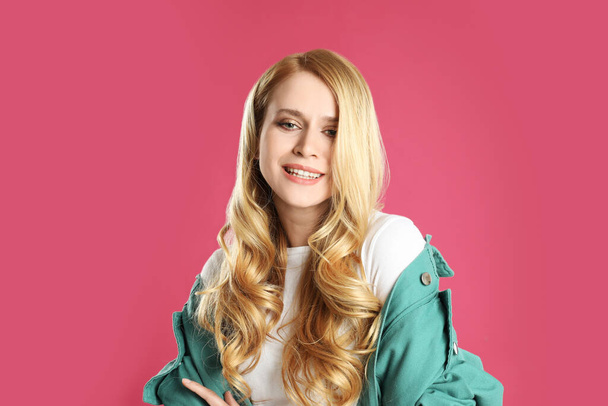 Portrait of beautiful young woman with dyed long hair on pink background - Φωτογραφία, εικόνα