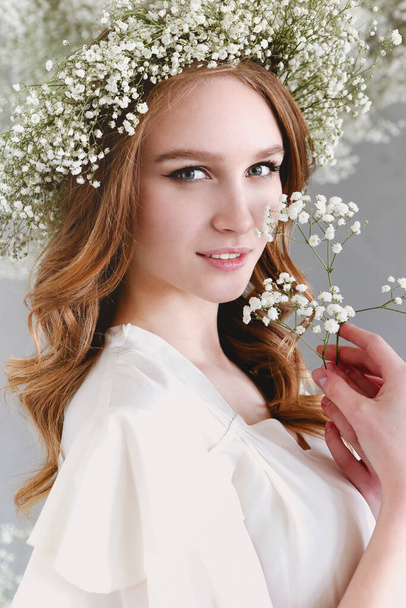 Portret zmysłowej blondynki z wieńcem kwiatów na szarym tle - Zdjęcie, obraz