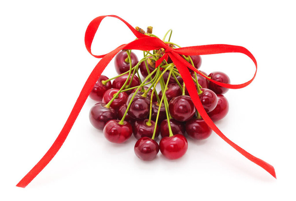 Cherries with a ribbon on a white background. - Фото, зображення