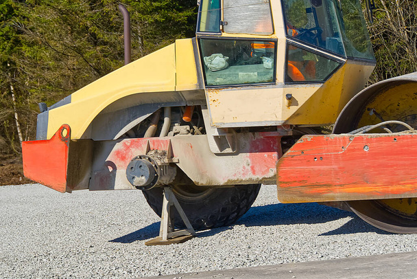 road roller with a broken wheel. Road roller compactor on highway ,these used to compact gravel, concrete or soil in road construction. - Photo, Image