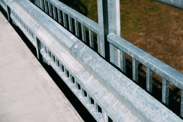 metal consctruction like a railing or paramet on a road - 写真・画像