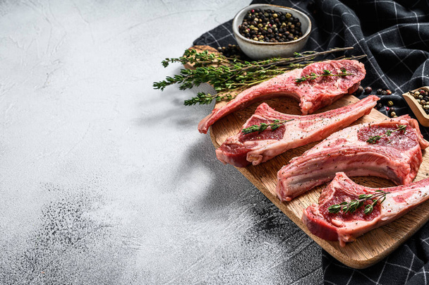 Raw fresh lamb ribs with pepper and thyme. Organic meat. White background. Top view. Copy space. - Fotó, kép