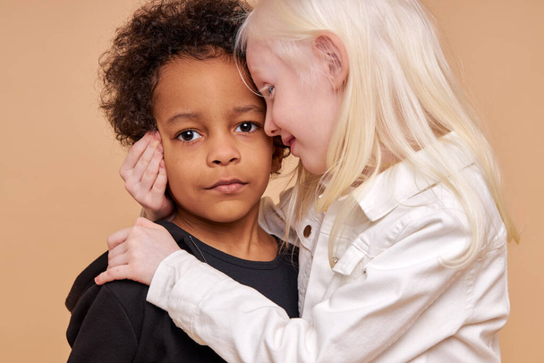 tender, sensitive albino girl hug african boy - Photo, image