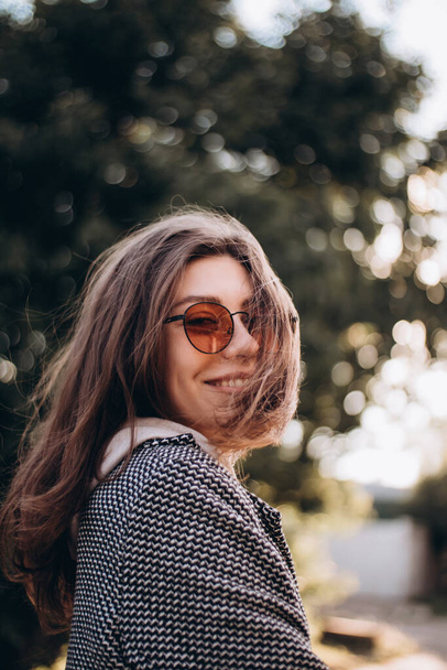 Beautiful happy young woman in sunglasses laughing in the park. happiness - Photo, image