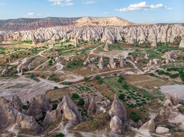 Aerial view of Goreme National Park, Tarihi Milli Parki, Turkey. The typical rock formations of Cappadocia with fairy chimneys and desert landscape. Travel destinations, holidays and adventure - Fotografie, Obrázek