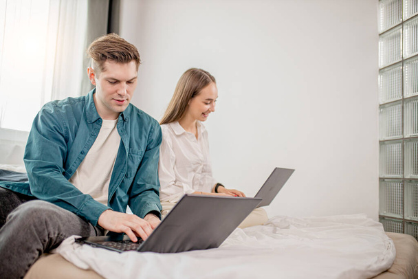 young caucasian couple work together at home using laptop - 写真・画像