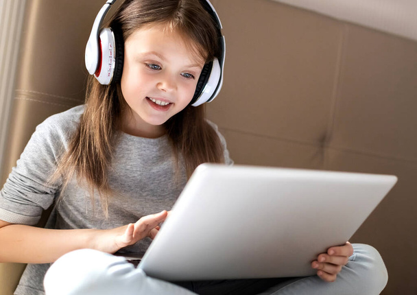 Cute little girl using laptop at home. Education, online study, home studying, technology, future, distance learning, homework, schoolgirl children lifestyle concept. Kids distance learning. - Foto, Bild