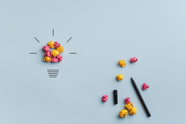 Lâmpada feita de papéis rosa e amarelo esmagado em uma imagem conceitual de brainstorming, inovação e criatividade
. - Foto, Imagem