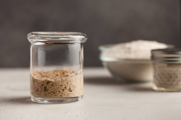  Sourdough for bread is active. Homemade rye whole grain flour sourdough. Starter leaven. Healthy eating concept.  - 写真・画像