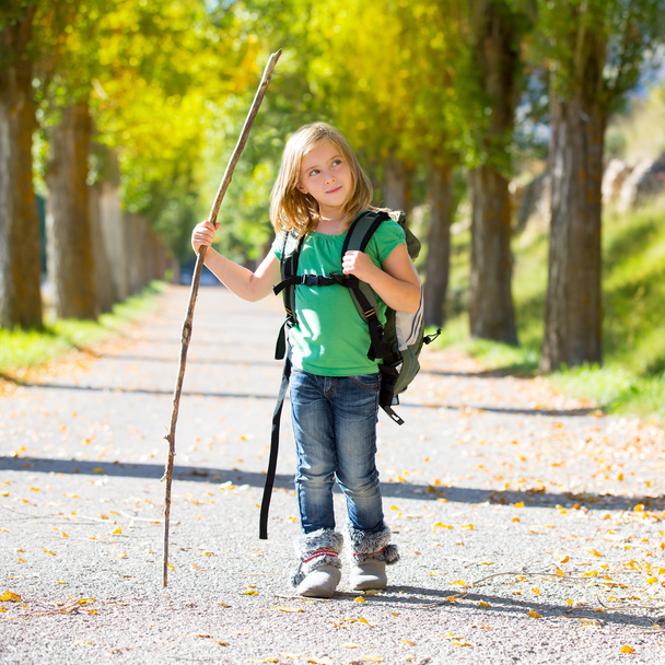 Blond explorer kid girl walking with backpack in autumn trees - Photo, Image
