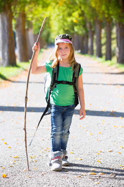 Blond explorer kid girl walking with backpack in autumn trees - Fotoğraf, Görsel